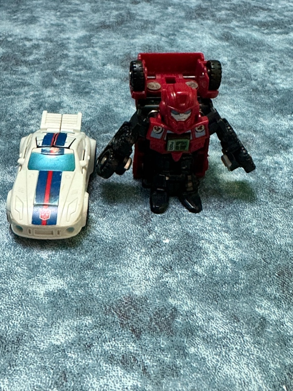 Hasbro Red and White Transformer Robot with Blue-Striped Race Car